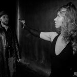 Ведущая Мафии Ольга в роли мирного жителя направляет пистолет на подозрительного типа