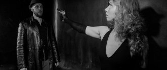 Mafia leader Olga, in the role of a civilian, points a gun at a suspicious character